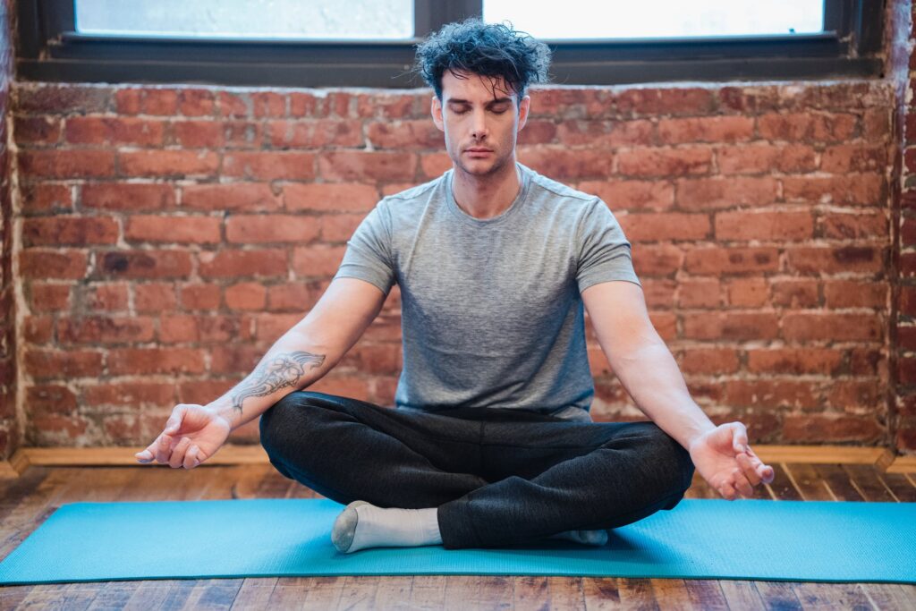 This photograph shows a man meditating. It’s a stock image so the individual should not be identified. It’s being used to give the impression that the aritcle discusses the benefits of mindfulness and changing perspective.