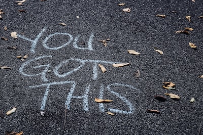 Stress relief with empowering message 'You've got this' scrawled on pavement.